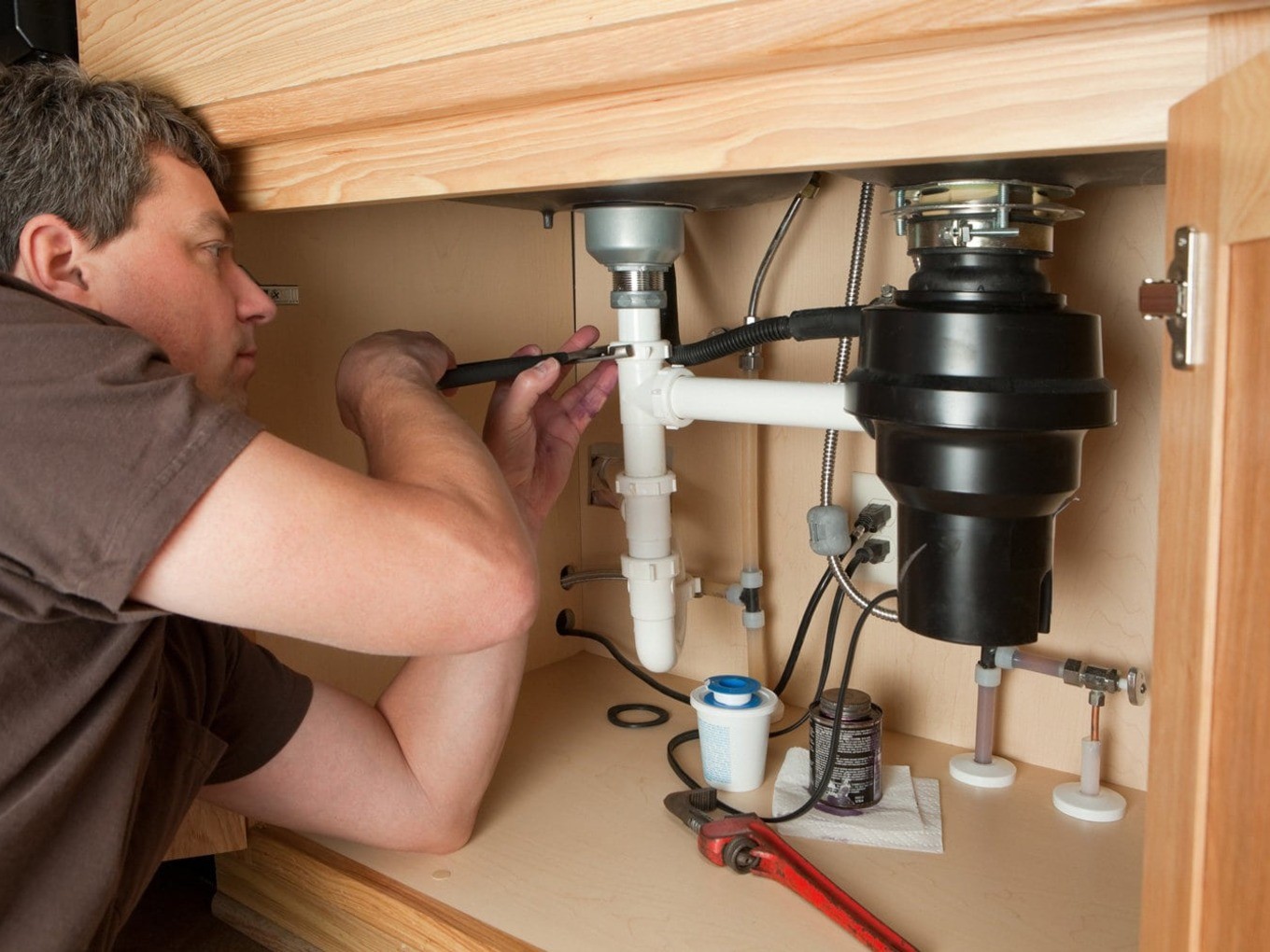 Who installs а garbage disposal plumber or electrician note