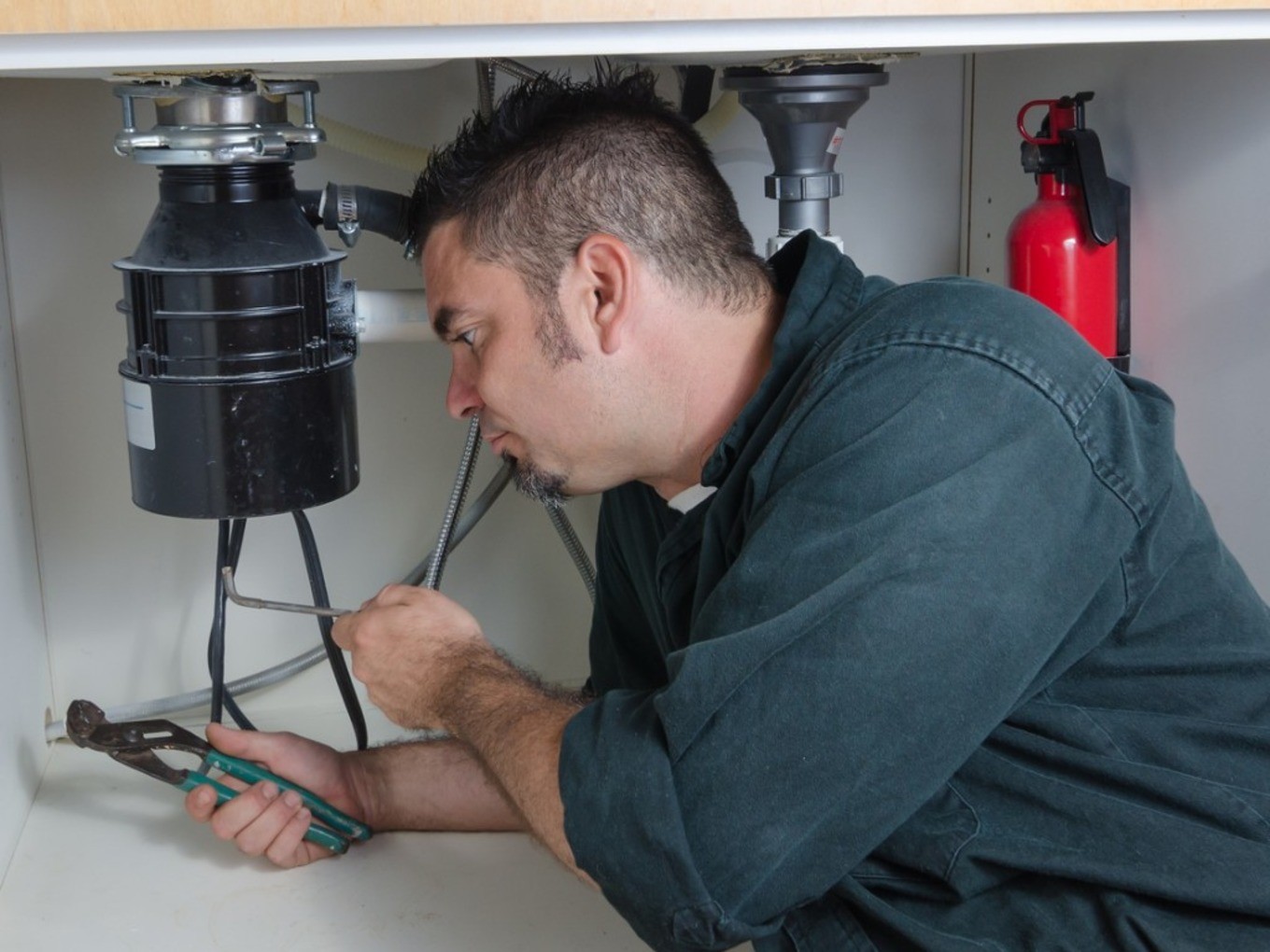 Who installs а garbage disposal plumber or electrician note